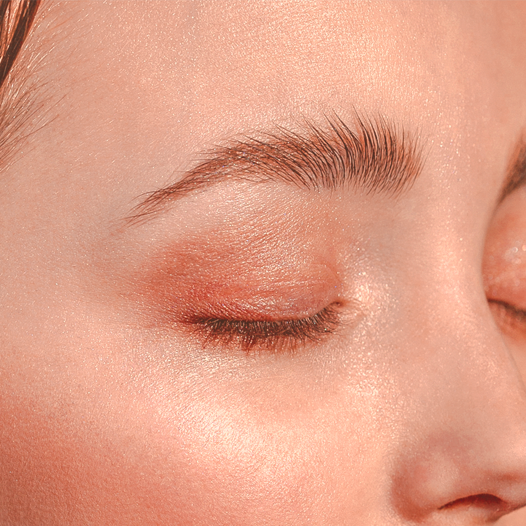 A close up of a woman's face and laminated lifted eyebrows