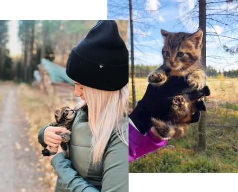 Girl rescuing stray cat from the woods