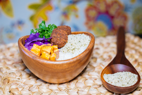 wooden bowl with falafel, rice, potato and hemp hearts