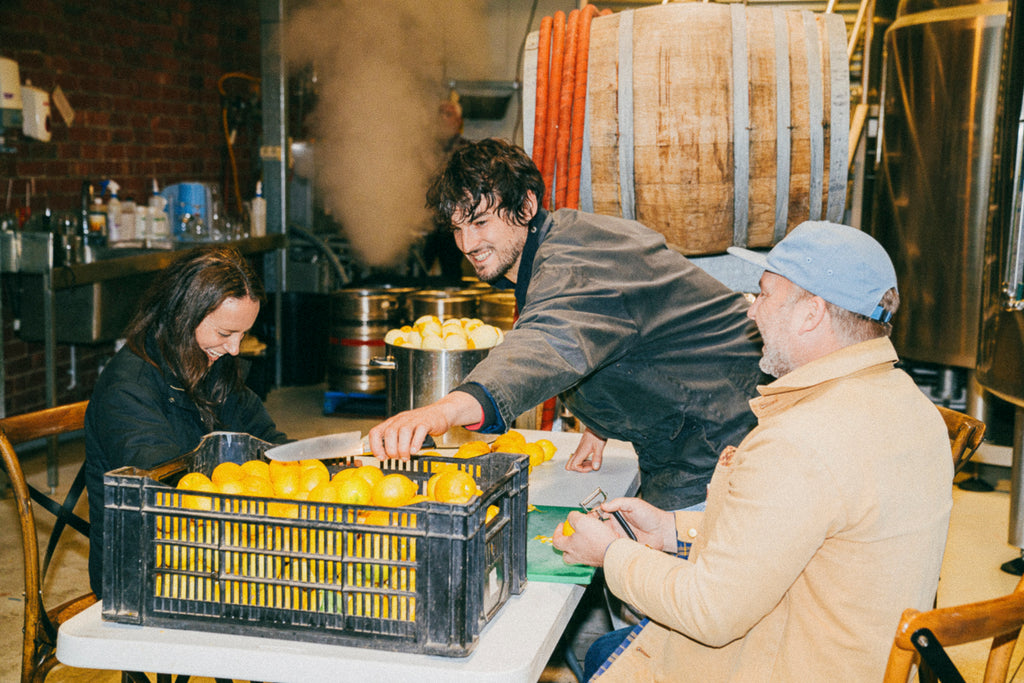 The Gospel team hand-peeling lemons with Benny Frazer of Yumbo Soda Co