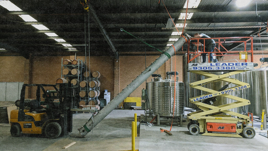 The Gospel Whiskey Co-Founder Andrew Fitzgerald installing the bespoke column still using a forklift, a pulley and some straps