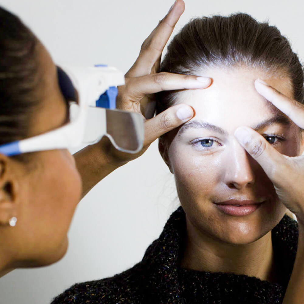 dermalogica professional examining a customers skin
