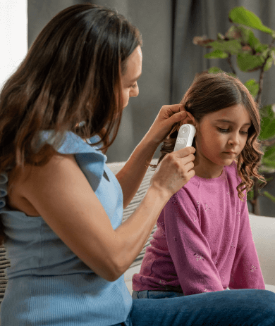 Featured image of mom helps daughter to measure temperature