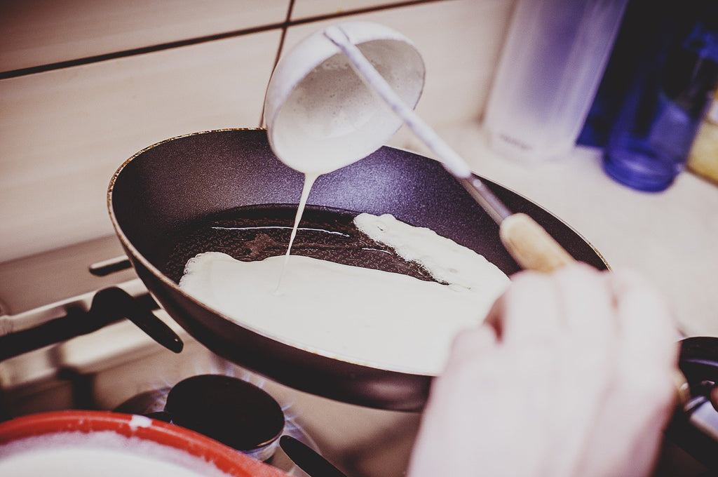 Use a ladle to pour the vegan pancake batter