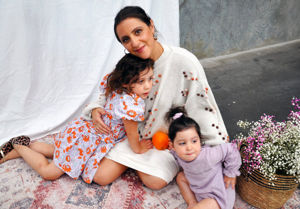 Me in a bobble knit sweater with my two daughters.