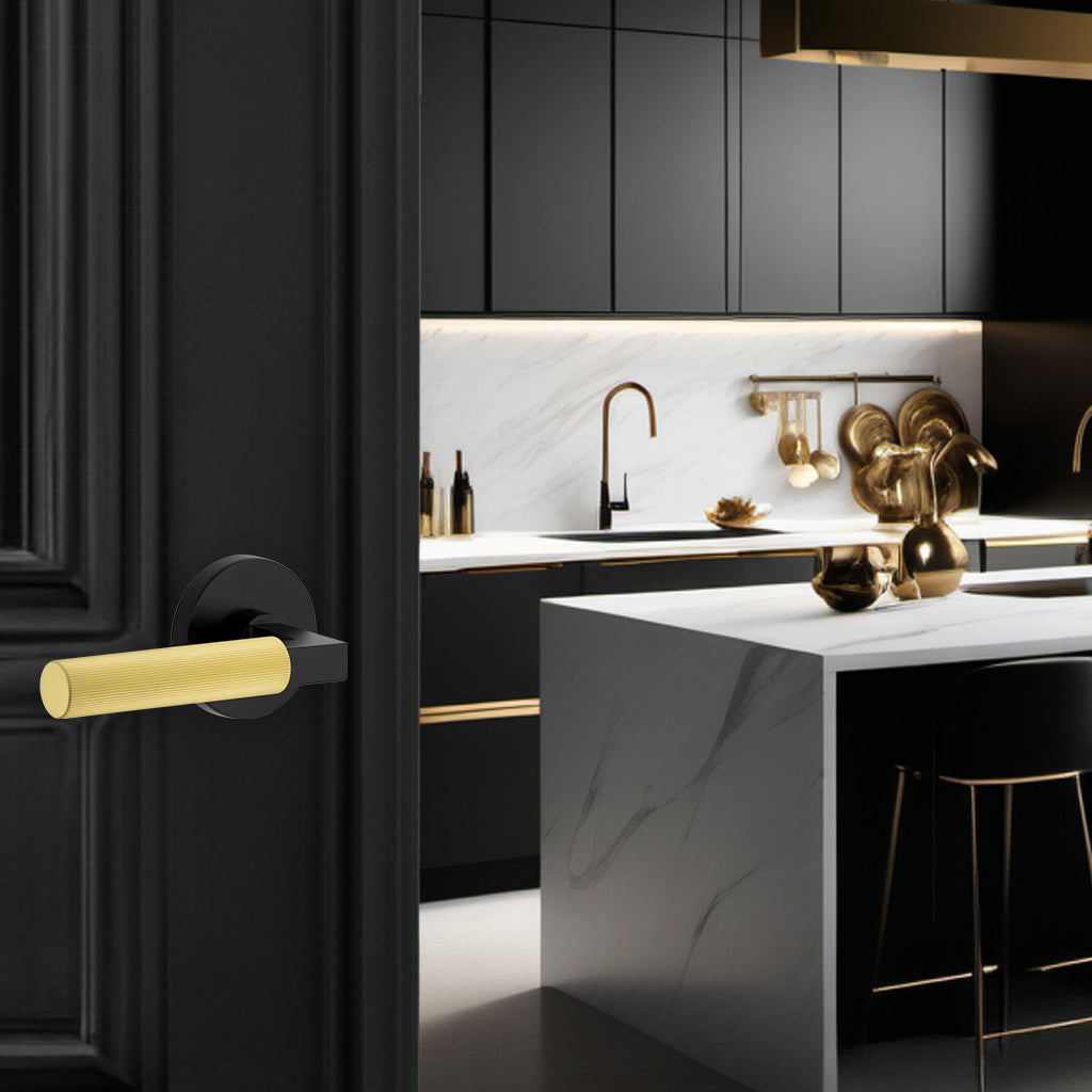 New black and gold kitchen with a black door opening into it. The black door has a Viaggio mixed metal lever on it.