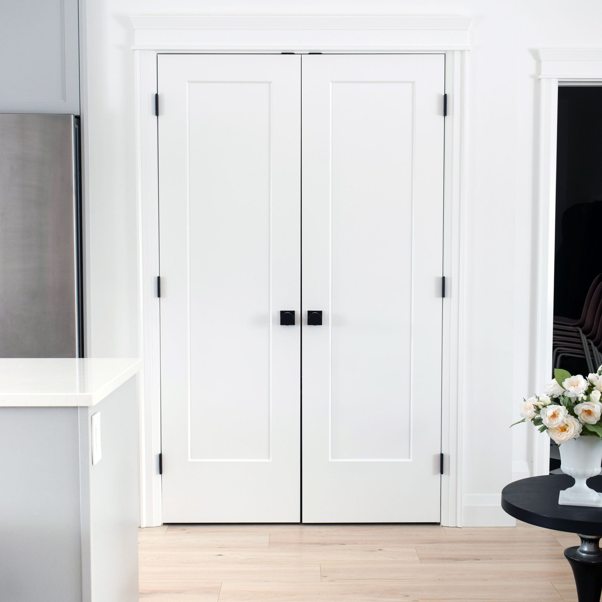 White french doors with two Quadrato Rosette with Quadrato Knobs in Satin Black.