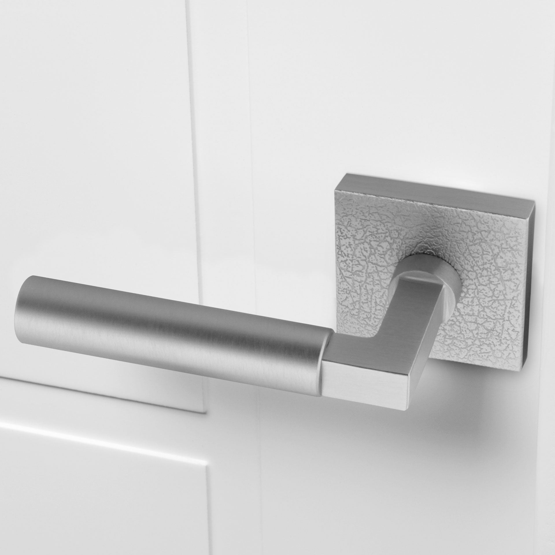 White door with Quadrato Leather Rosette with Contempo Lever in Satin Nickel.