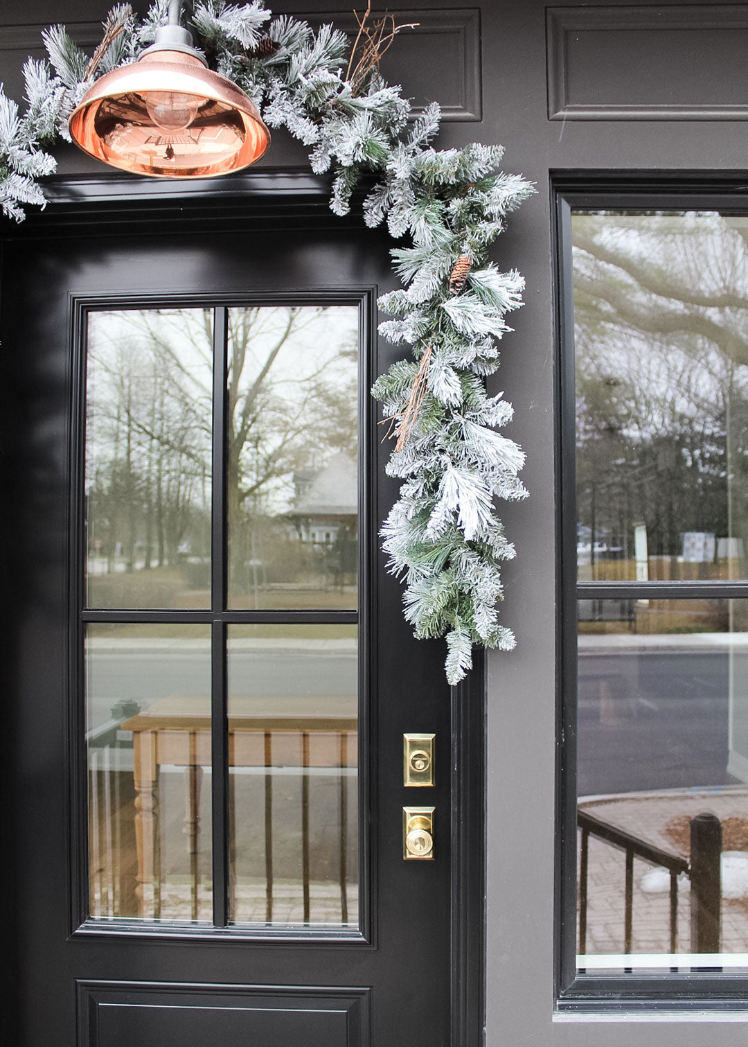 black front door storefront store with Nostalgic brass Door Hardware