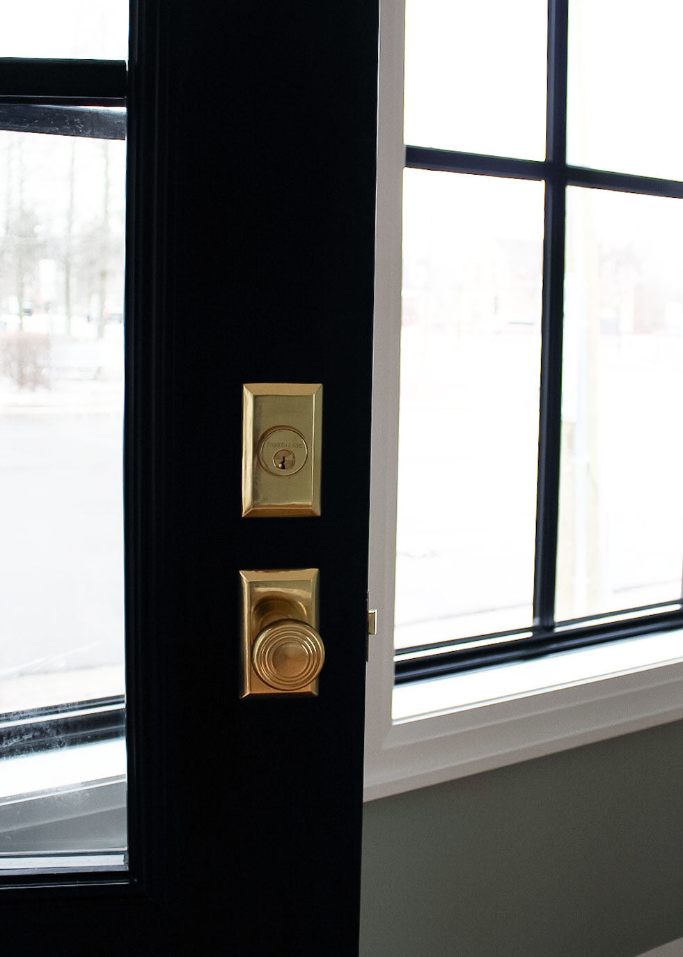 black front door storefront store with Nostalgic brass Door Hardware