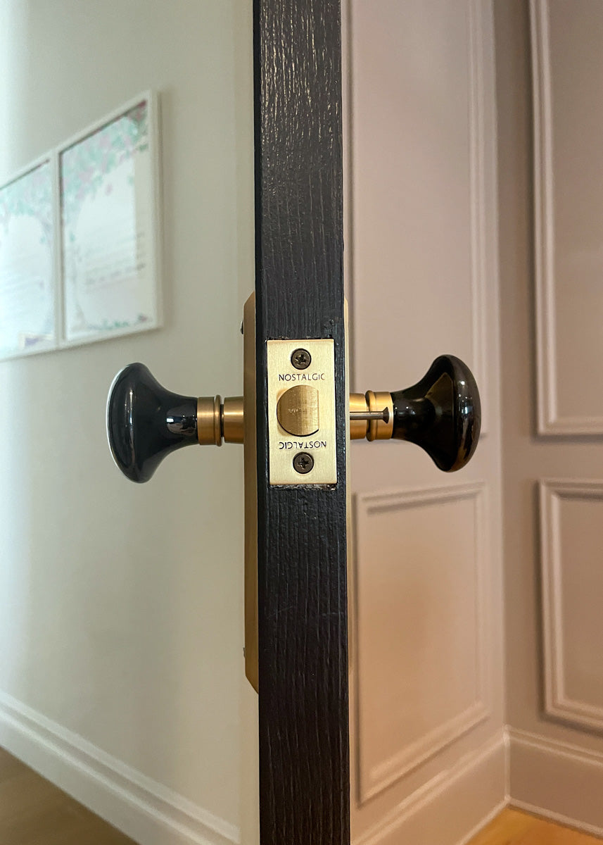black door antique brass hardware crystal doorknob knob camille kurtz home nostalgic warehouse vintage