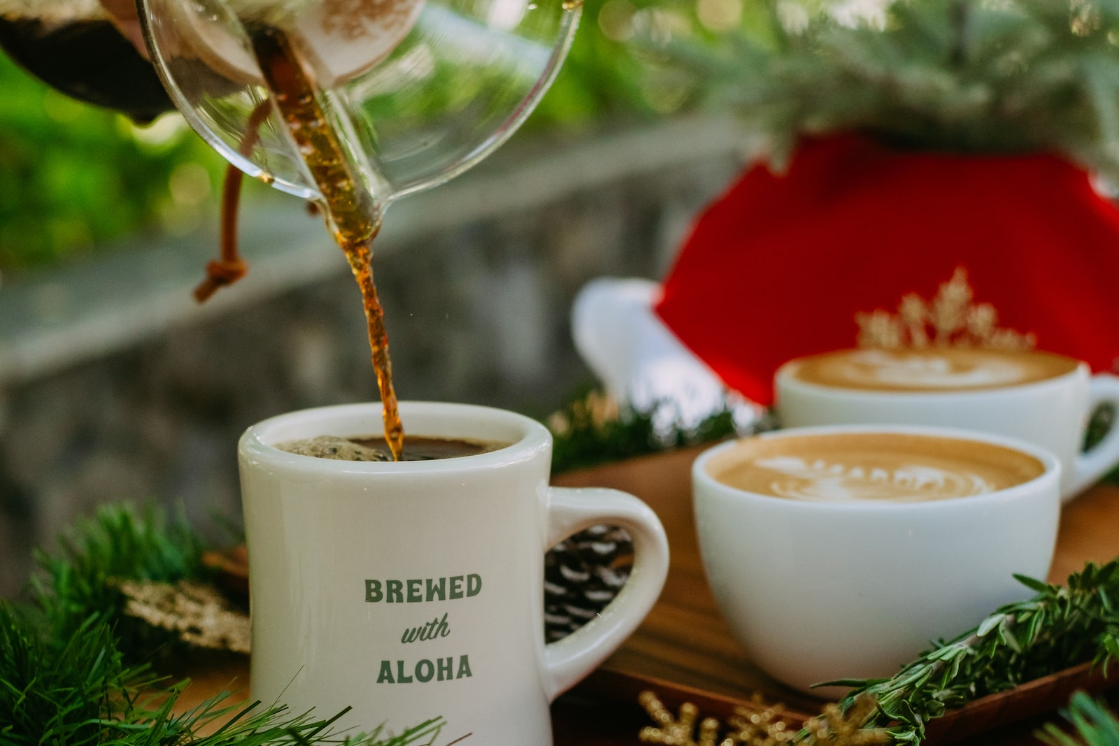 Honolulu Coffee's Christmas Blend being poured from a Chemex into a mug