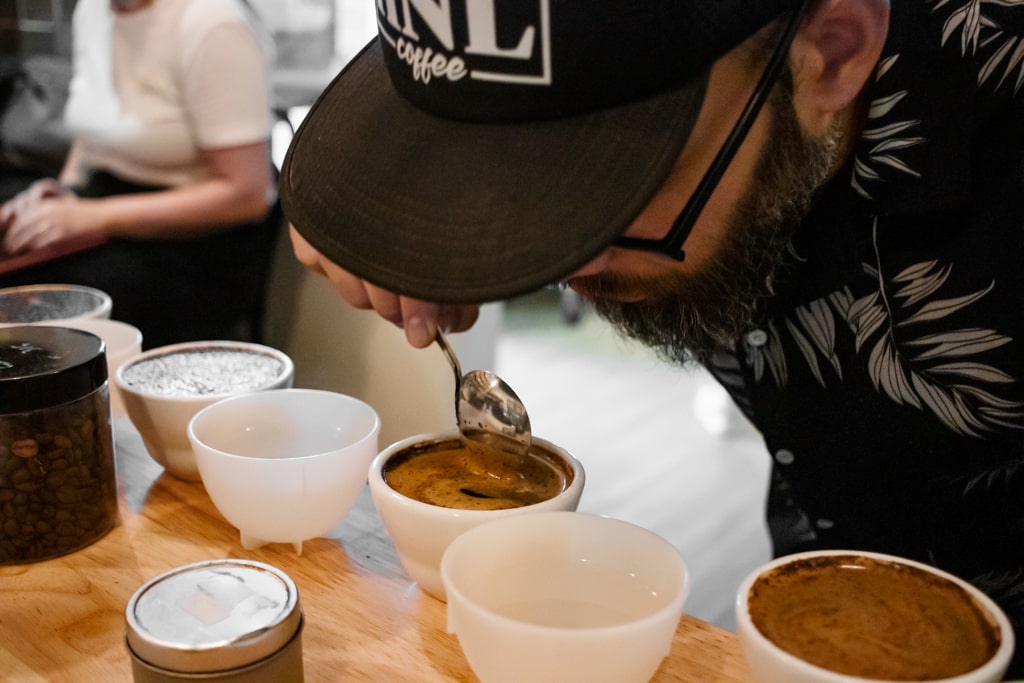 Head Roaster, Tim, evaluating the aromas of the freshly brewed coffee