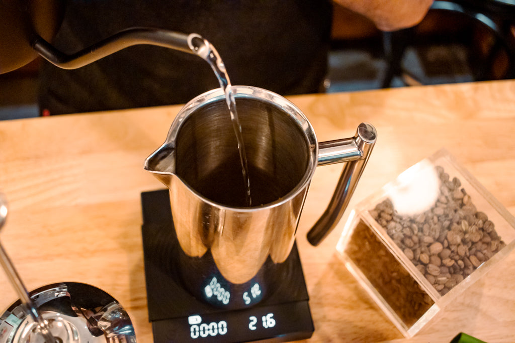 Pouring in hot water (205 degrees F) to preheat the French Press brewer.