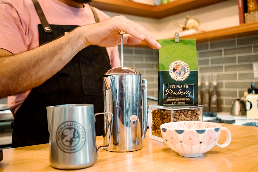 Tim slowly pressing down the plunger/filter of the French Press with barely the weight of his hands.