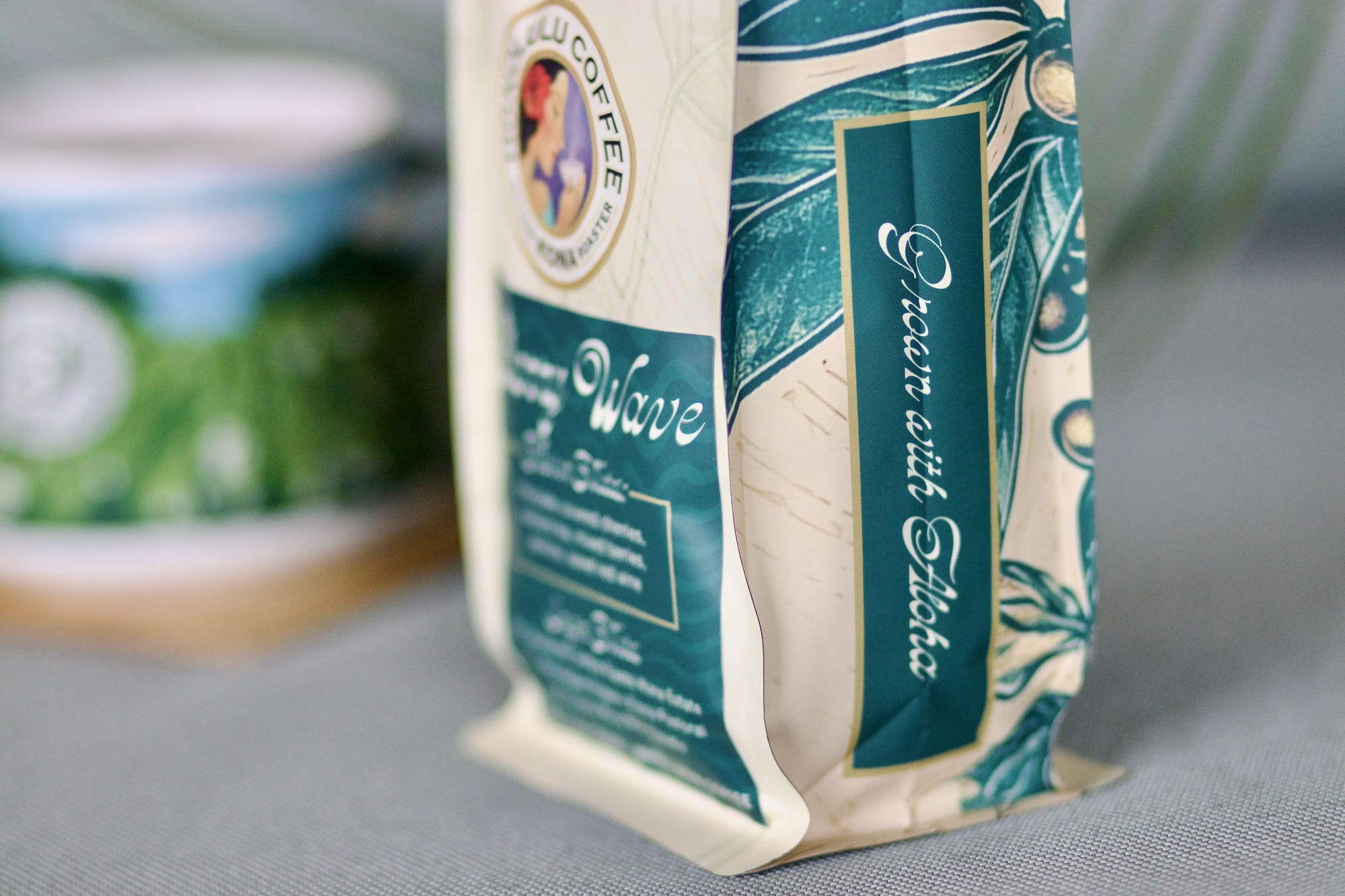 The side view of the new Cherry Wave coffee blend bag with the text "Grown with Aloha"