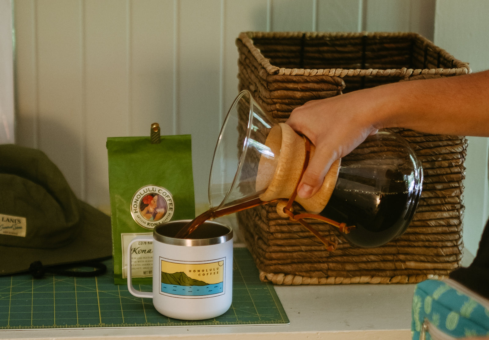 Pouring Kona coffee from a Chemex into a mug