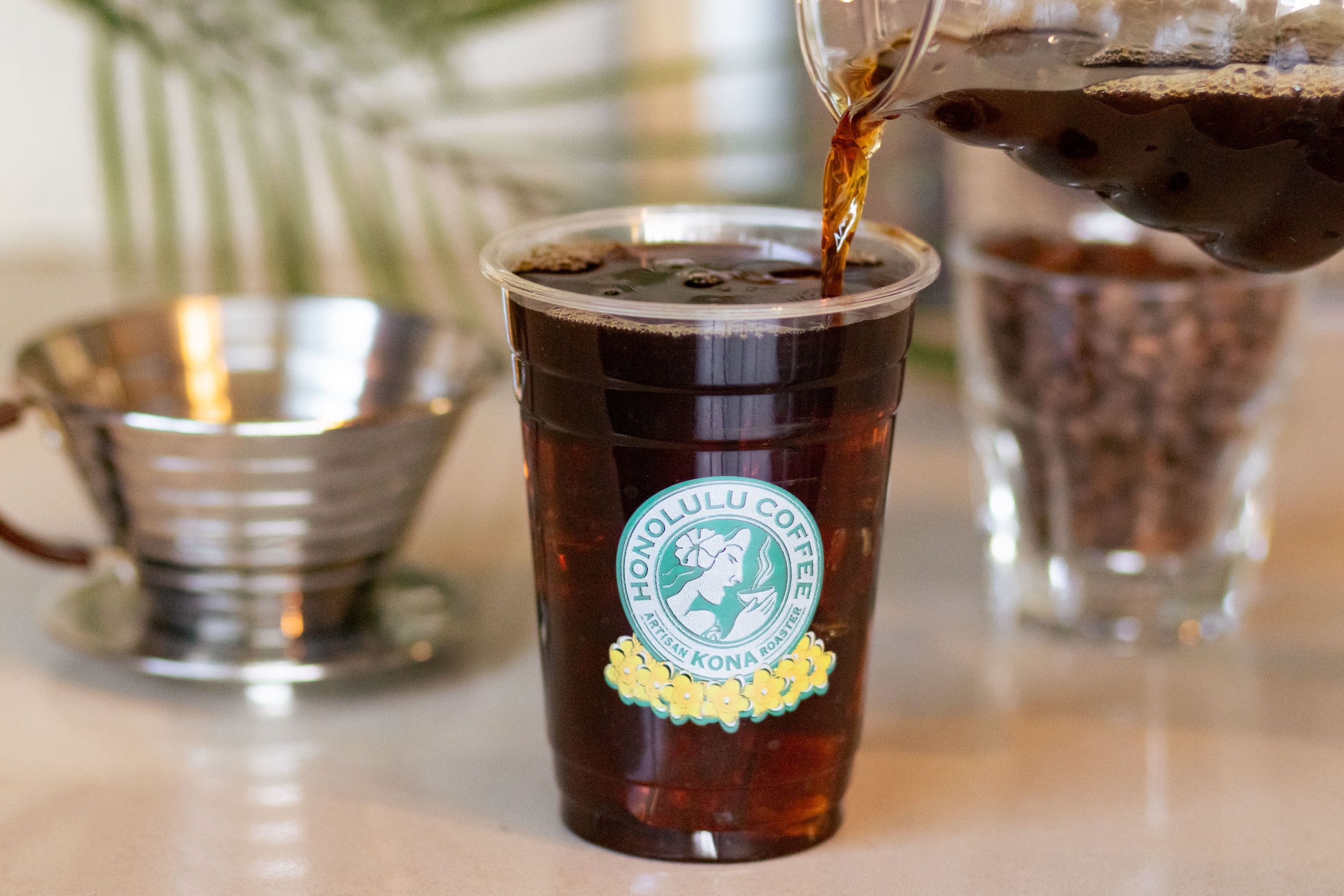 Pouring a freshly brewed iced Kalita into serving cup