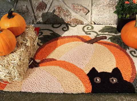 Black cat in pumpkin patch rug