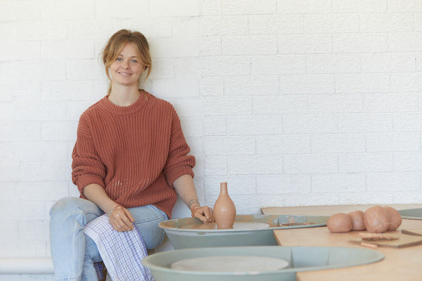 Jennifer sitting in her cafe and pottery studio, Stone Studio.