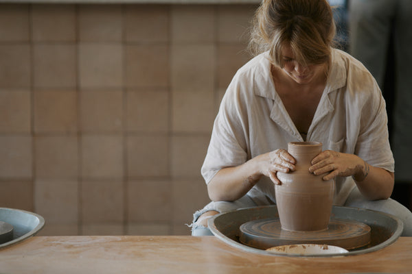 Jennifer throwing on the wheel in her Kingscliff pottery studio.