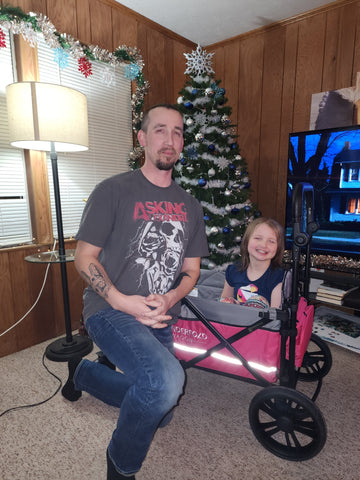 happy pair at Christmas after getting their new WonderFold Cares wagon
