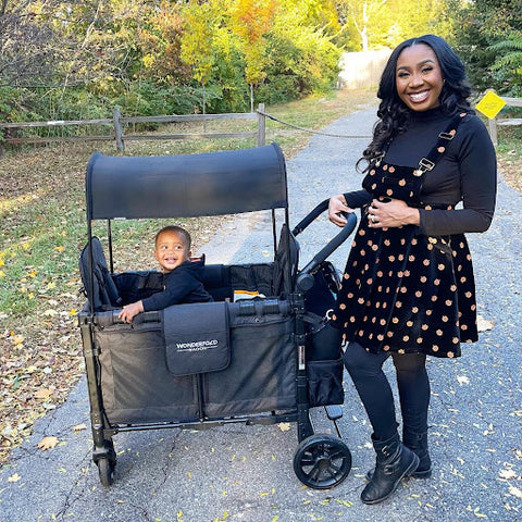 A mom and her toddler enjoying an autumn scenery