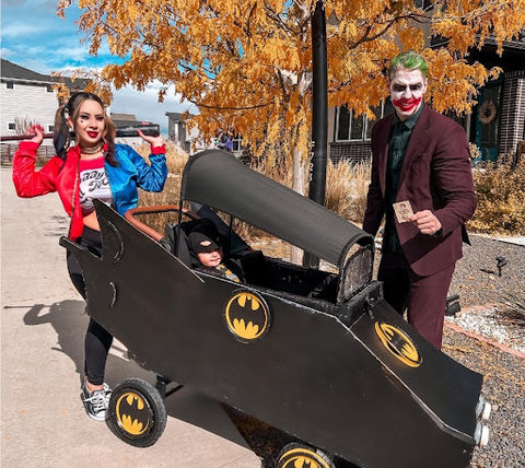  A family showing off in their Batman-themed Halloween costume