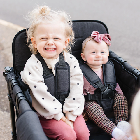 happy kids sitting comfortably in their WonderFold stroller wagon