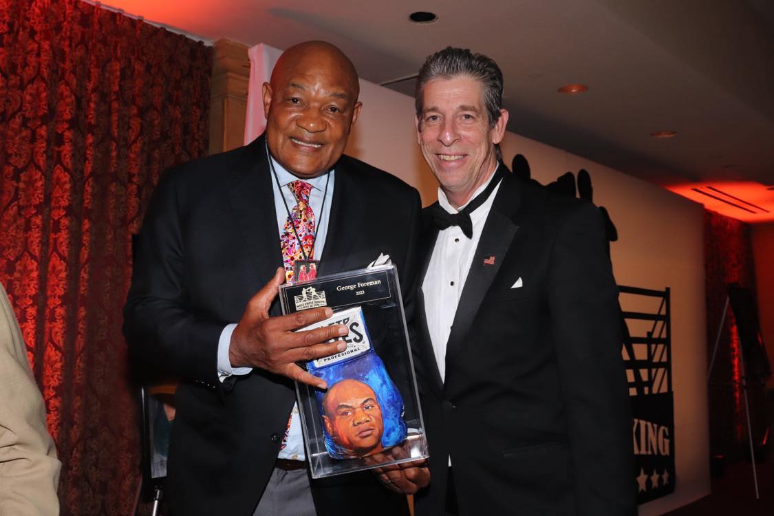 George Foreman holding our display case at the 2023 West Coast Boxing Hall of Fame