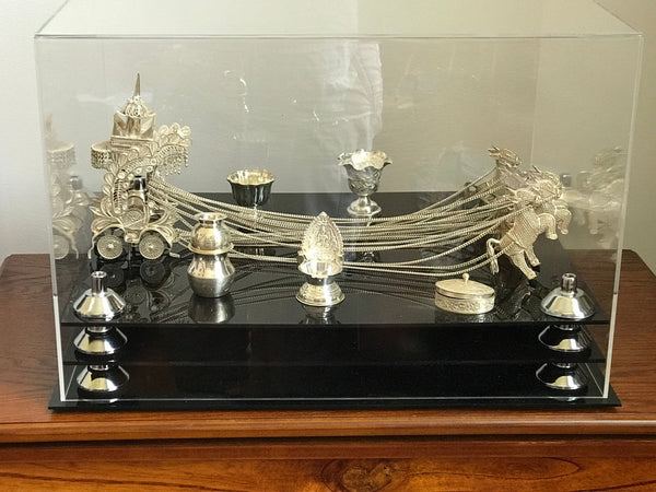 A beautiful silver Murti of the Hindu God Krishna is shown in a display case manufactured by Better Display Cases