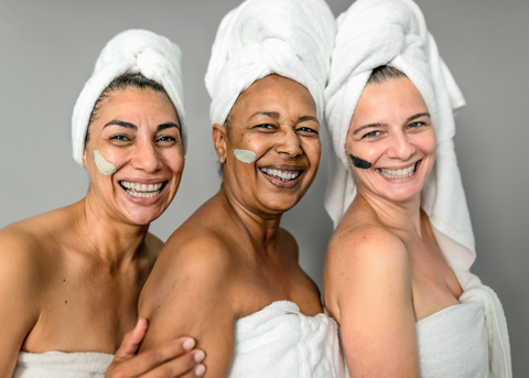 Group of three women at spa in towels with eye masks