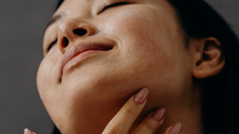 Asian woman applying Cecile's Essential Elixir