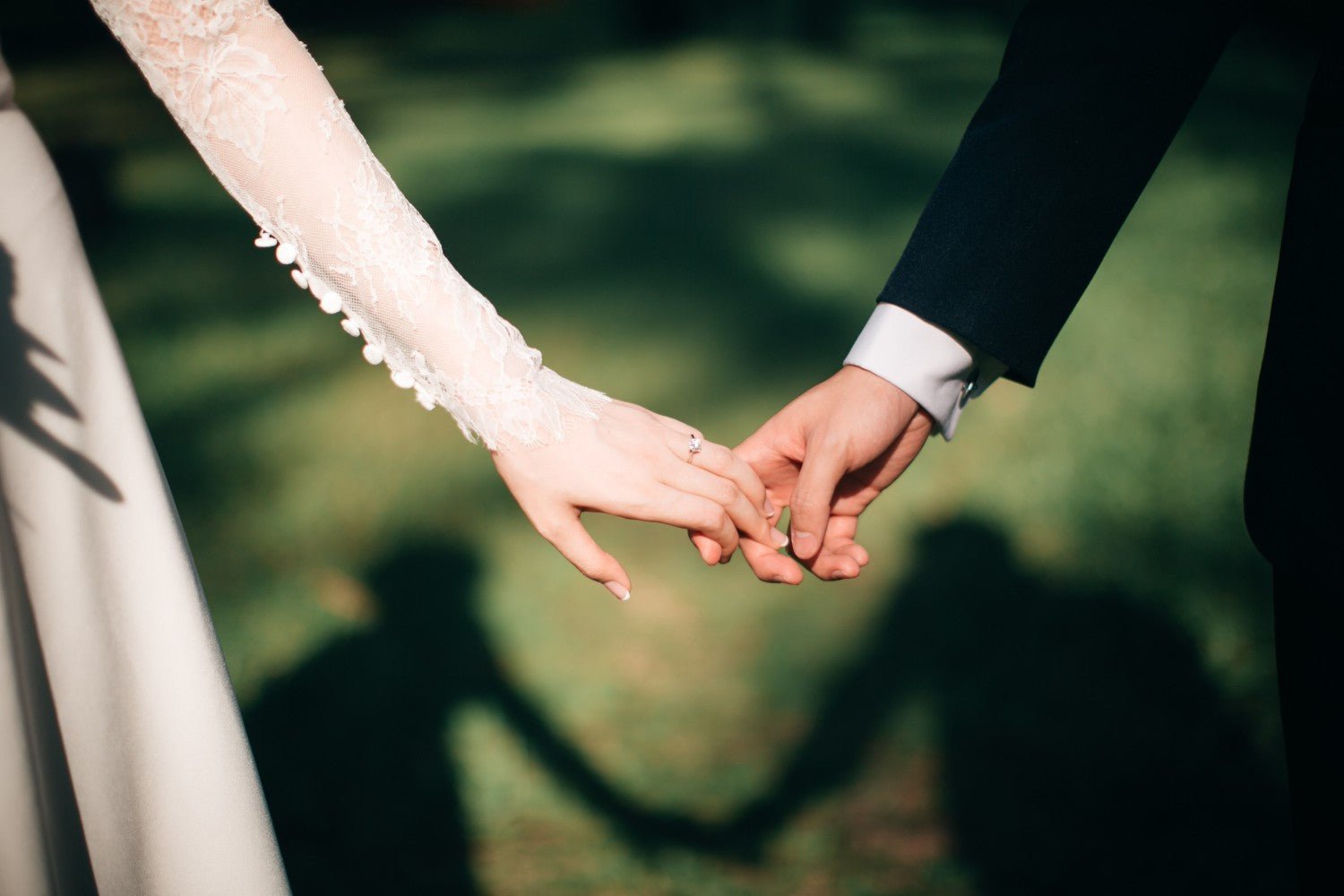 Bride and groom closeup holding hands