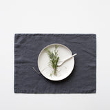 Plate setting on a dark grey placemat