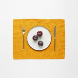 Plate setting on a mustard yellow placemat