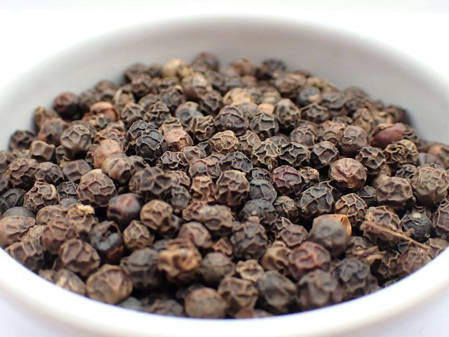close up of a bowl of dried peppercorns