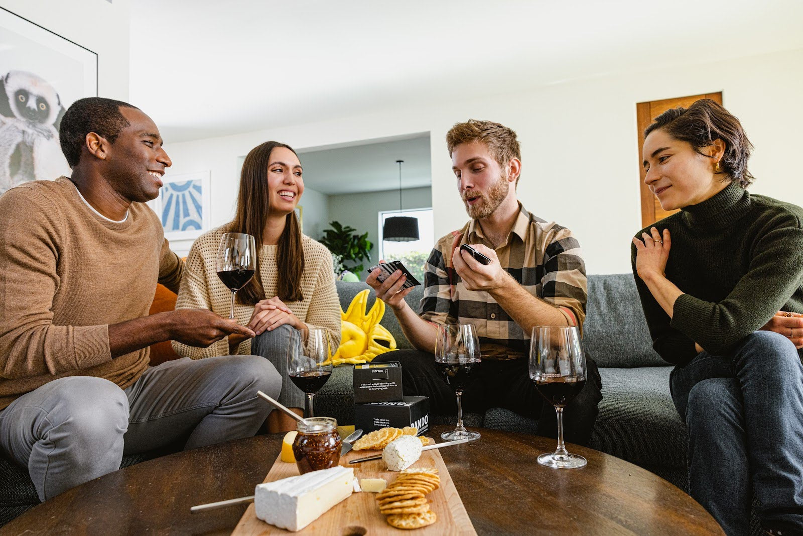 Group of adults around a table with wine and charcuterie