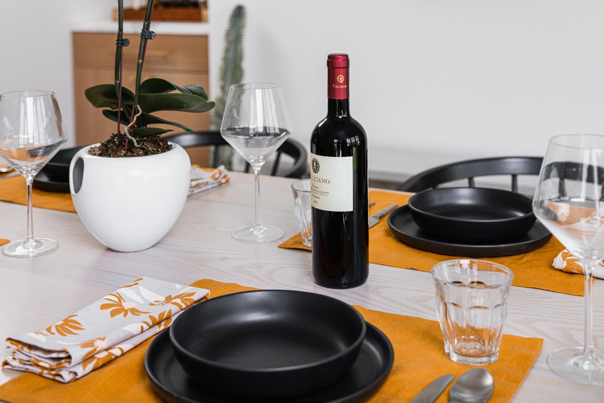 Dining table fully set with wine bottle