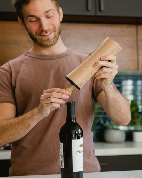 Man uncorking a bottle of wine
