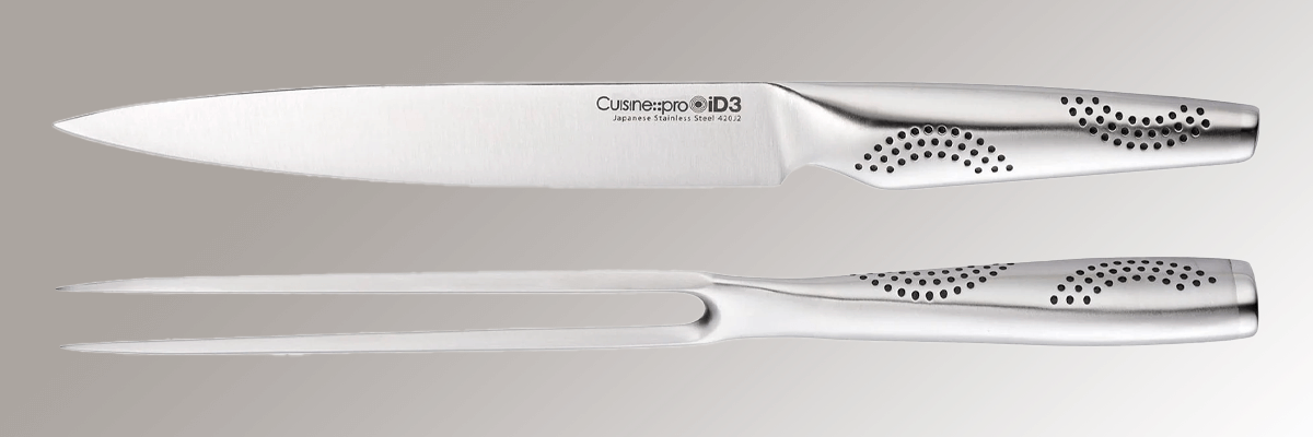 Stainless steel carving knife set over a grey background
