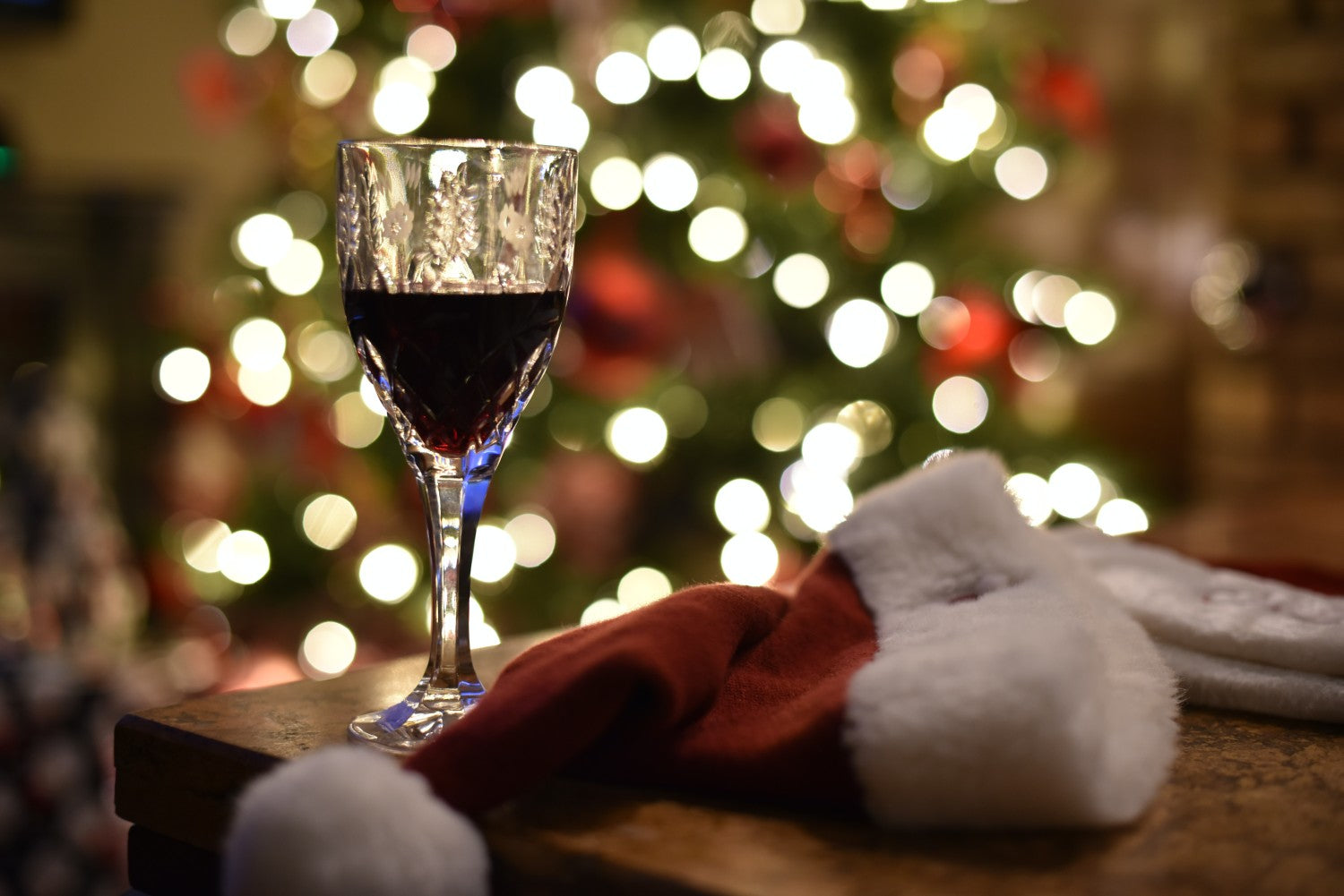 wine glass next to a santa hat