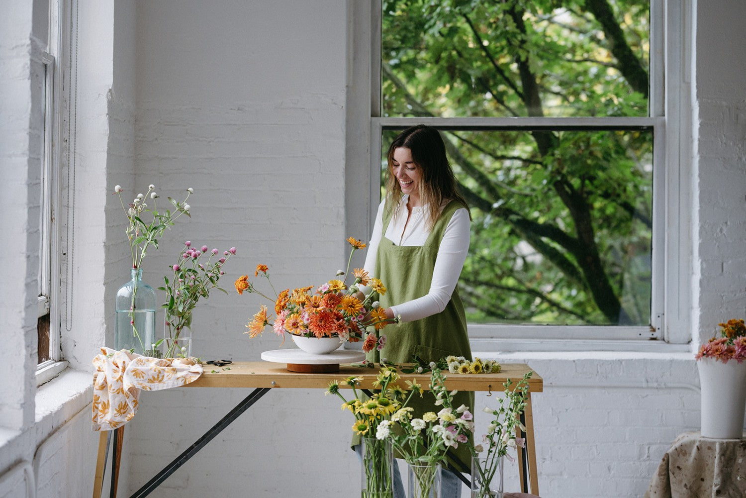 Woman arranging flowers on table