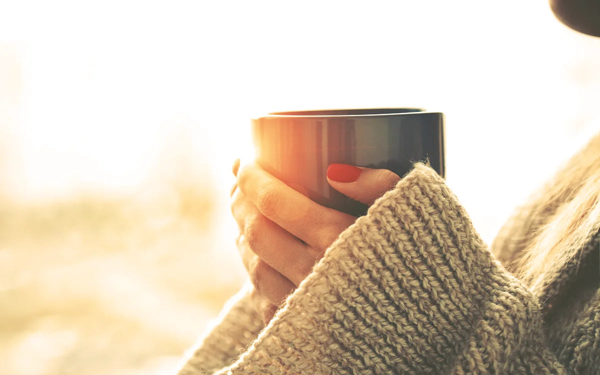 Woman's hands holding mug