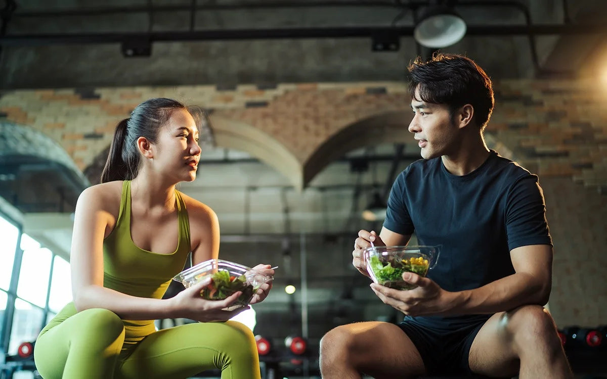 Man And Woman Eating Healthy In Gym