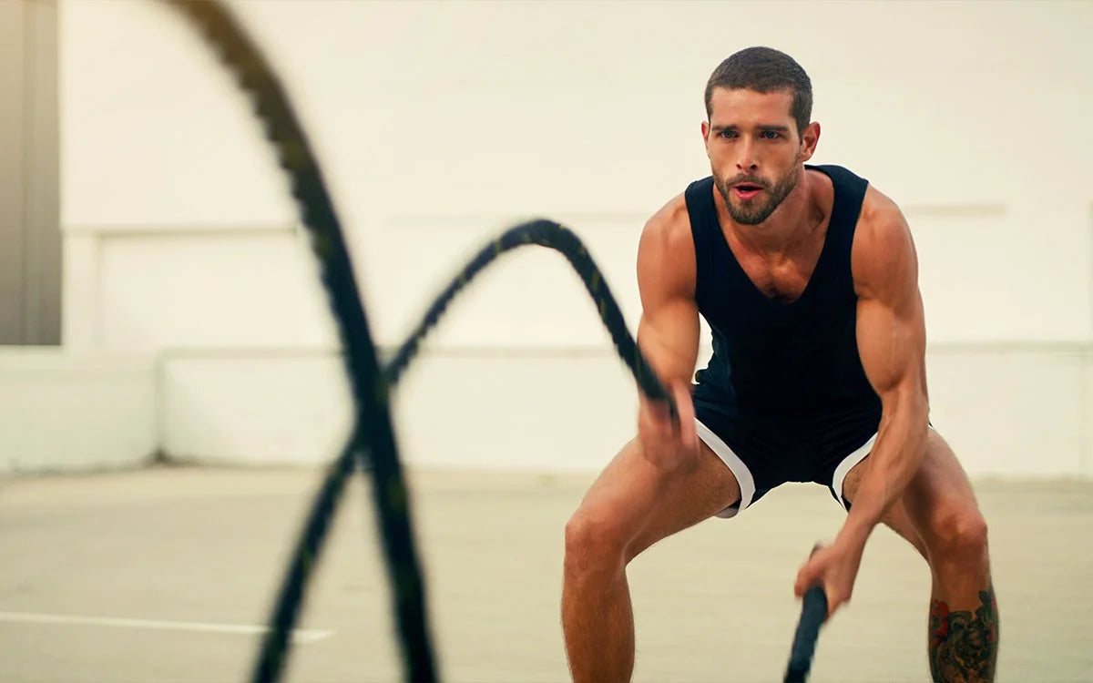 Man exercising with ropes