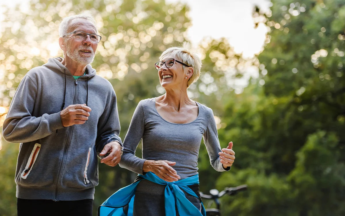 Old couple running outside