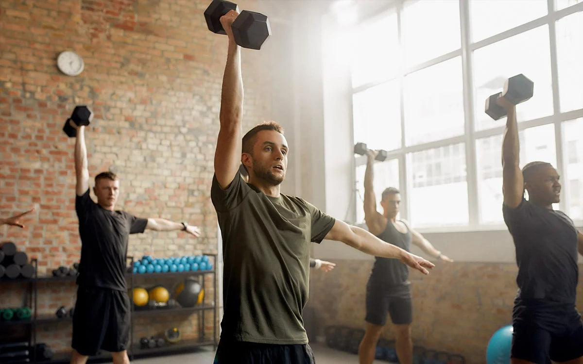 People Lifting Weights In Gym To Build Muscle