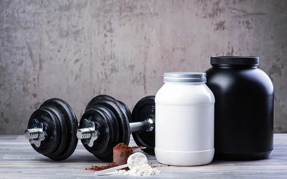 Protein Powder And Dumbbells