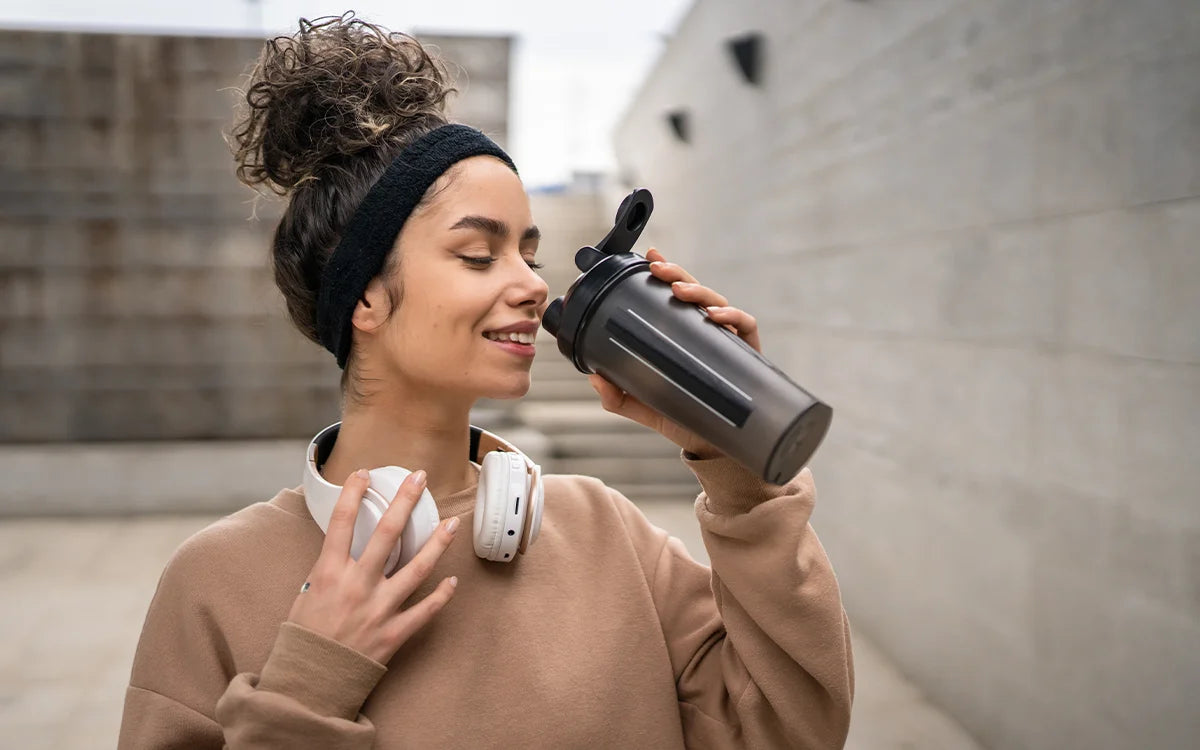 woman drinking a protein shake